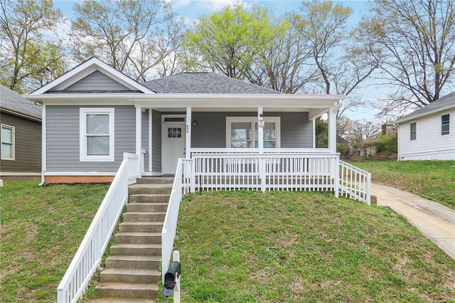 bungalow-style house featuring stairway, a shingled roof, a porch, and a front yard