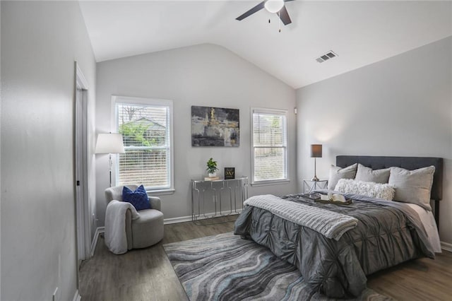 bedroom with visible vents, baseboards, ceiling fan, wood finished floors, and vaulted ceiling