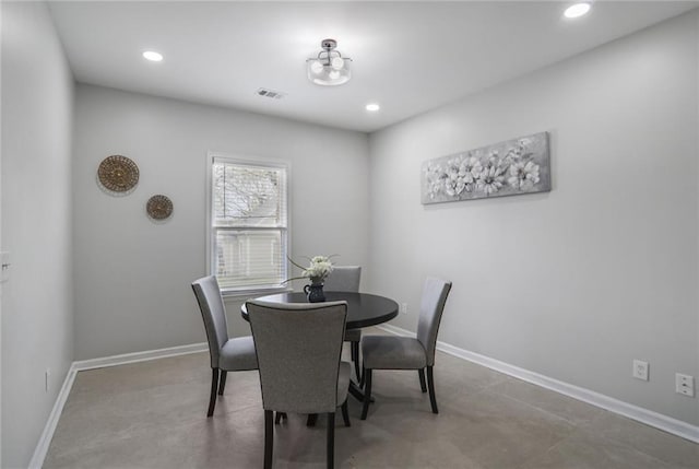 dining area featuring baseboards, visible vents, concrete floors, and recessed lighting
