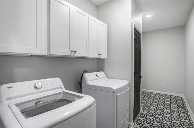 laundry room with washer and clothes dryer, cabinet space, baseboards, and tile patterned floors
