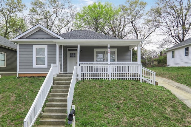 bungalow-style home with a porch, stairs, and a front lawn