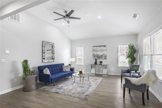 living room with ceiling fan, visible vents, vaulted ceiling, and wood finished floors