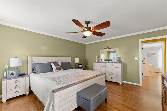 bedroom with ornamental molding, a ceiling fan, baseboards, and wood finished floors