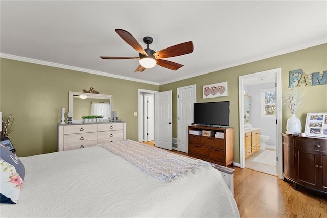 bedroom featuring ensuite bath, light wood-style flooring, ceiling fan, and crown molding