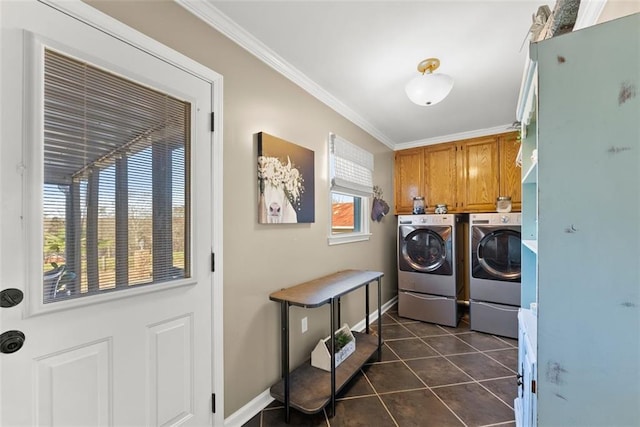 laundry area with dark tile patterned flooring, baseboards, independent washer and dryer, cabinet space, and crown molding