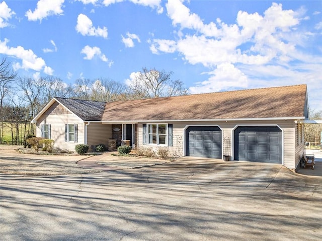 ranch-style home featuring concrete driveway and an attached garage