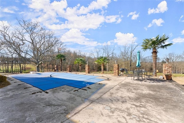 view of swimming pool with a patio area and a covered pool