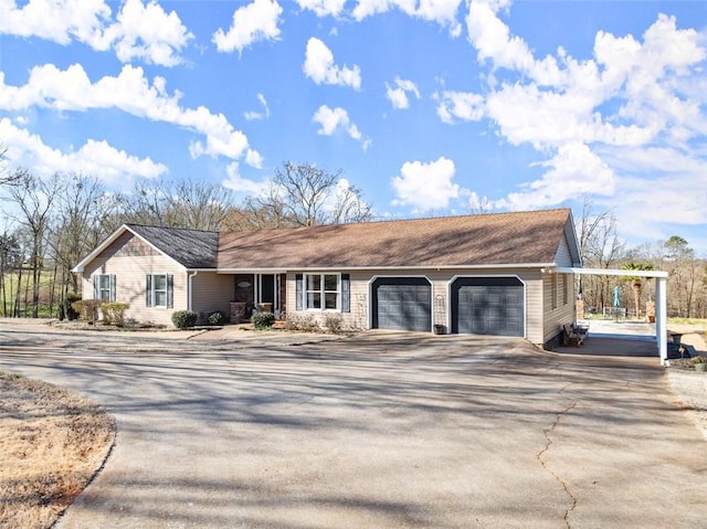 ranch-style house with a garage and concrete driveway