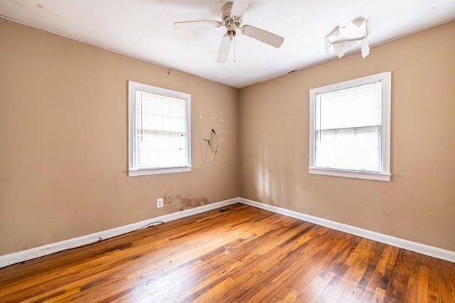 unfurnished room with hardwood / wood-style flooring, plenty of natural light, and ceiling fan