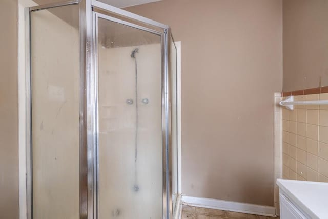 bathroom featuring tile walls and walk in shower