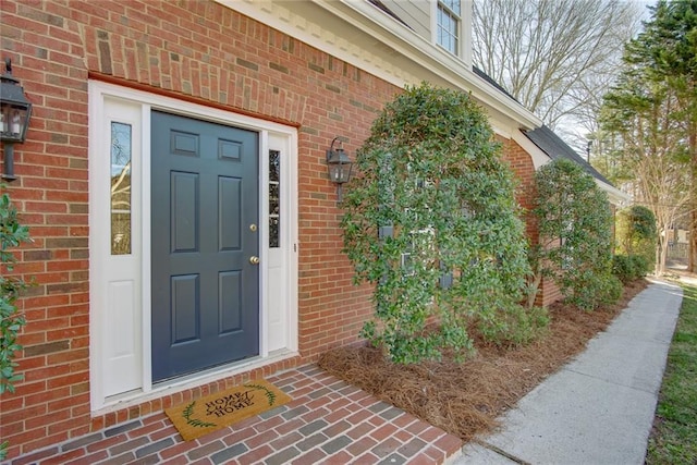 property entrance featuring brick siding