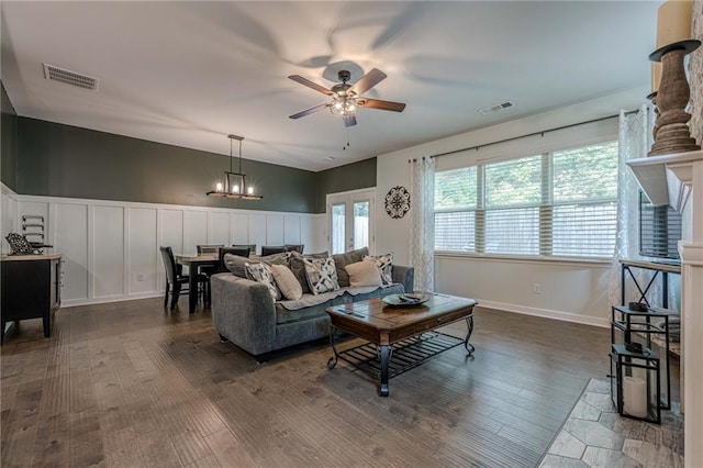 3291 Wild Basil Ln, Buford, GA 30519 - living room featuring a ceiling fan, dark wood finished floors, a decorative wall, a chandelier, and wainscoting