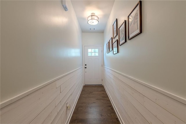 3291 Wild Basil Ln, Buford, GA 30519 - doorway with a wainscoted wall, wood walls, and dark wood-type flooring