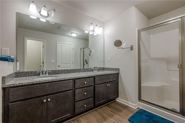 3291 Wild Basil Ln, Buford, GA 30519 - full bath with wood finished floors, a shower stall, and double vanity
