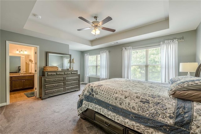 3291 Wild Basil Ln, Buford, GA 30519 - bedroom featuring a tray ceiling, light carpet, ceiling fan, and connected bathroom