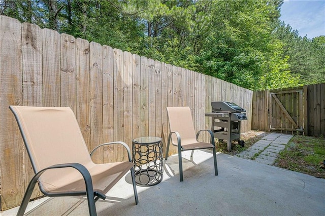 3291 Wild Basil Ln, Buford, GA 30519 - fenced backyard featuring a patio area, area for grilling, and a gate