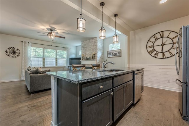 3291 Wild Basil Ln, Buford, GA 30519 - kitchen with stainless steel appliances, ceiling fan, dark stone counters, and wood finished floors