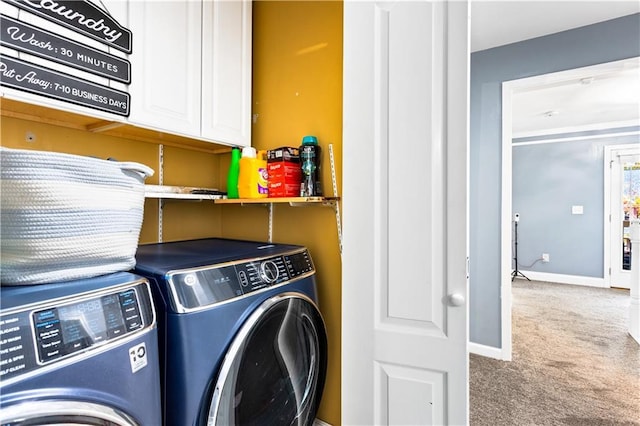 laundry area with cabinets, separate washer and dryer, and light colored carpet