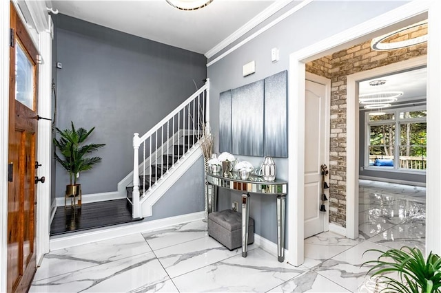 foyer featuring brick wall and ornamental molding