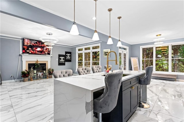 dining room featuring an inviting chandelier, sink, and ornamental molding