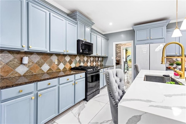 kitchen featuring stainless steel appliances, dark stone countertops, and decorative light fixtures