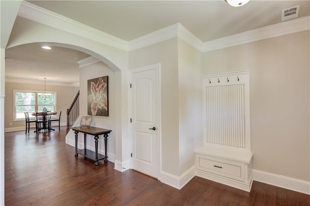 interior space with ornamental molding and dark hardwood / wood-style floors