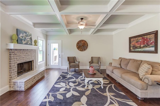 living room featuring coffered ceiling, a brick fireplace, dark wood-type flooring, and beam ceiling