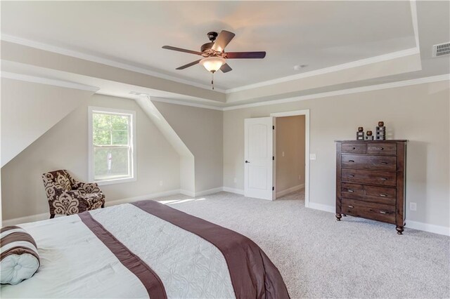 carpeted bedroom featuring ceiling fan, ornamental molding, and a raised ceiling