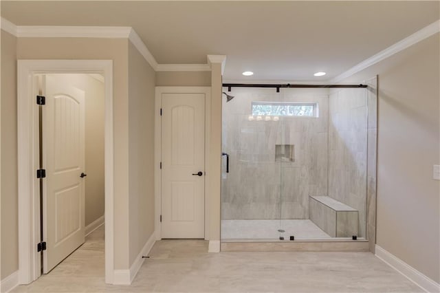 bathroom with ornamental molding and an enclosed shower