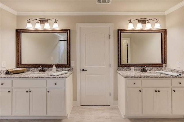 bathroom with crown molding and vanity