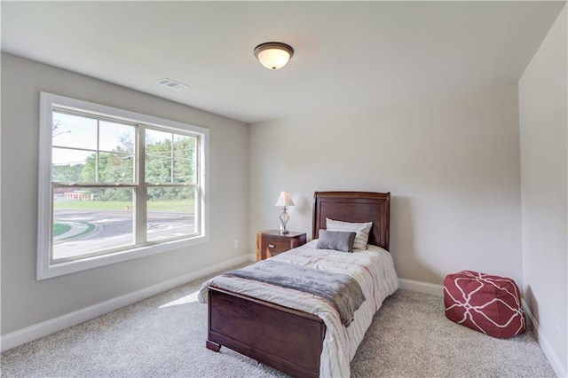 bedroom featuring light colored carpet