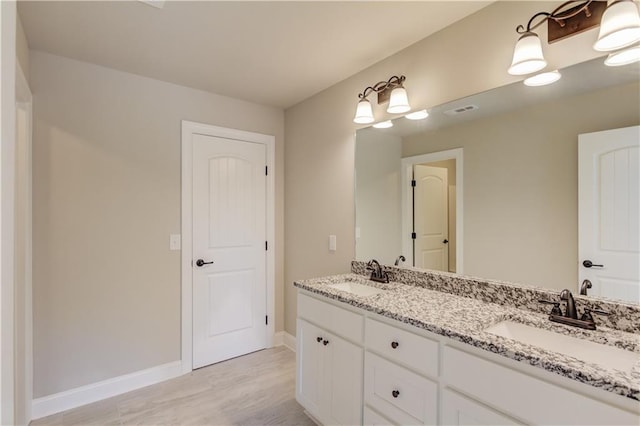 bathroom featuring vanity and wood-type flooring