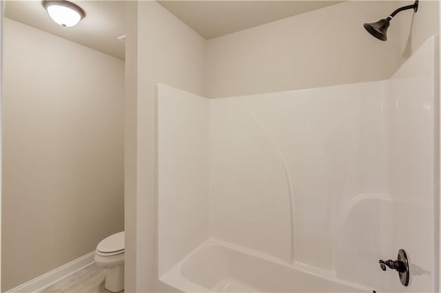 bathroom with toilet and bathing tub / shower combination