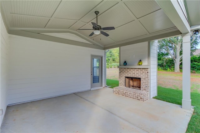 view of patio with an outdoor brick fireplace and ceiling fan