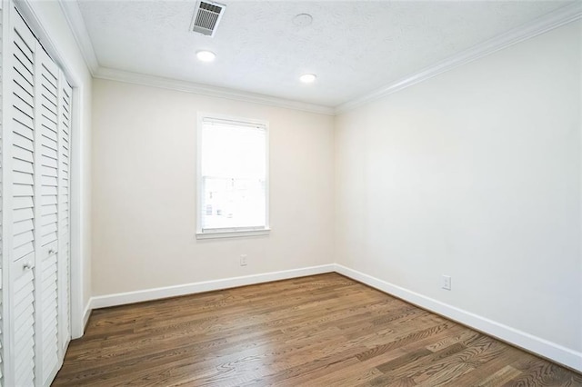 700 Hill Meadow Dr, Dacula, GA 30019 - unfurnished bedroom with visible vents, crown molding, baseboards, and wood finished floors