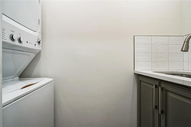 700 Hill Meadow Dr, Dacula, GA 30019 - laundry area with stacked washer and dryer, cabinet space, and a sink