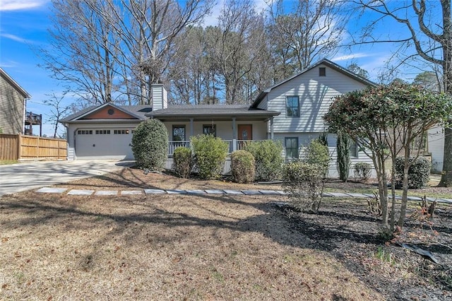 700 Hill Meadow Dr, Dacula, GA 30019 - tri-level home featuring fence, driveway, covered porch, a chimney, and a garage