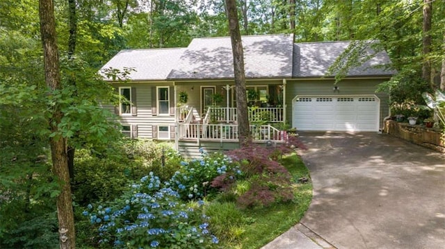 1526 Oakleaf Dr, Auburn, GA 30011 - view of front of home with an attached garage, concrete driveway, a porch, and stairway