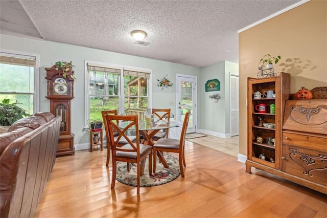 1526 Oakleaf Dr, Auburn, GA 30011 - dining room featuring light wood-style floors, a textured ceiling, and baseboards