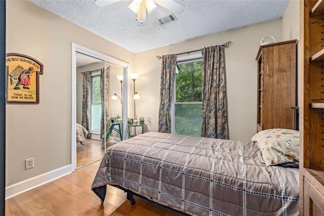 1526 Oakleaf Dr, Auburn, GA 30011 - bedroom with a textured ceiling, baseboards, wood finished floors, and ceiling fan