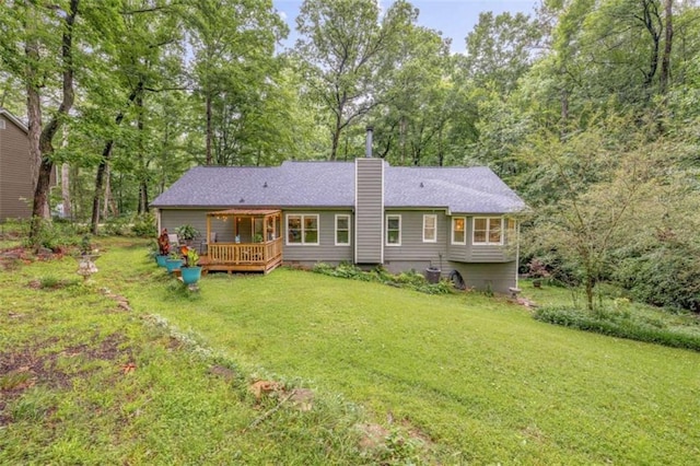 1526 Oakleaf Dr, Auburn, GA 30011 - rear view of house with a deck, a chimney, a lawn, and view of wooded area