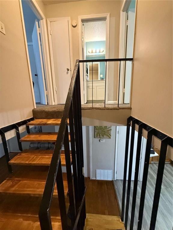 stairway featuring hardwood / wood-style floors