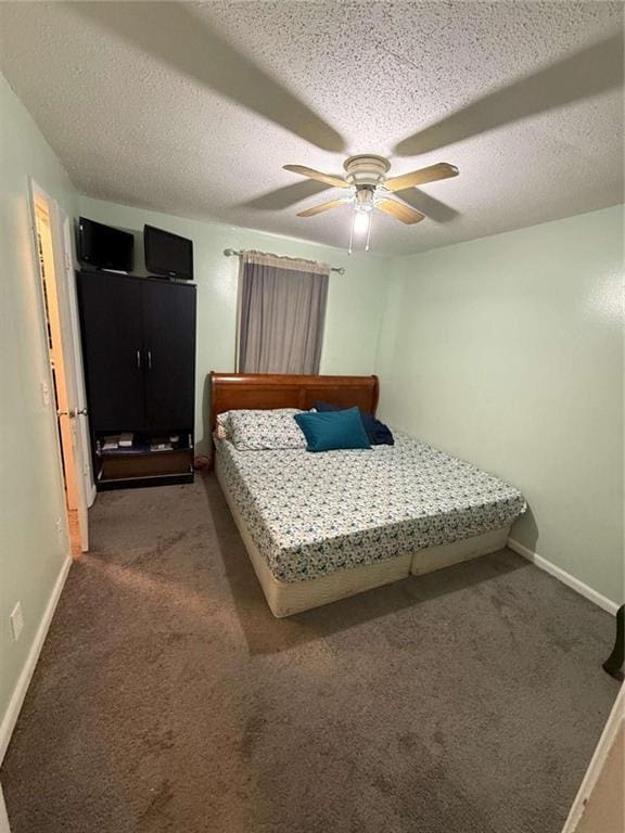 carpeted bedroom featuring ceiling fan and a textured ceiling