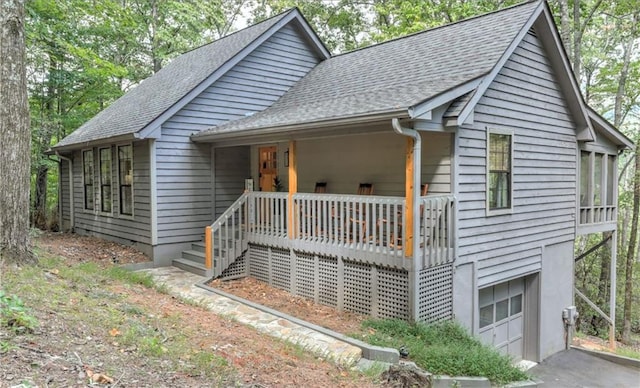 view of front of house featuring a garage and a porch