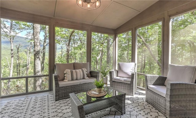 sunroom / solarium featuring plenty of natural light and lofted ceiling