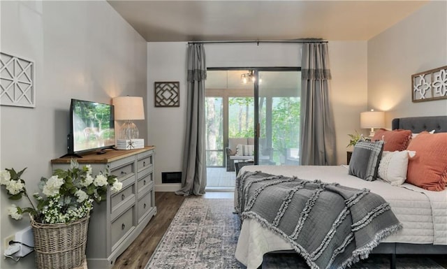 bedroom featuring access to exterior and dark hardwood / wood-style floors