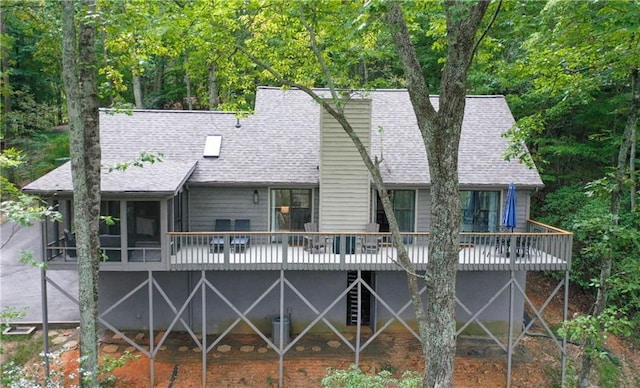 back of property featuring a deck