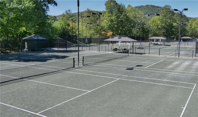 view of tennis court with a gazebo