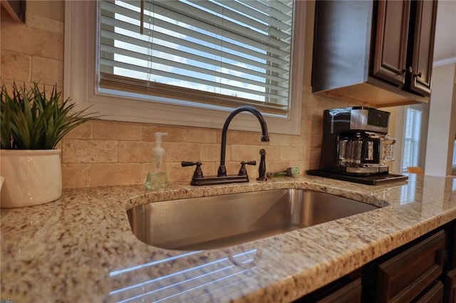 200 Baumgard, Locust Grove, GA 30248 - kitchen view of decorative backsplash, light stone countertops, and dark brown cabinetry