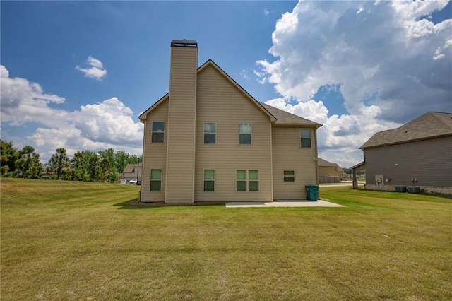 200 Baumgard, Locust Grove, GA 30248 - rear view of property with a patio area, a chimney, and a lawn